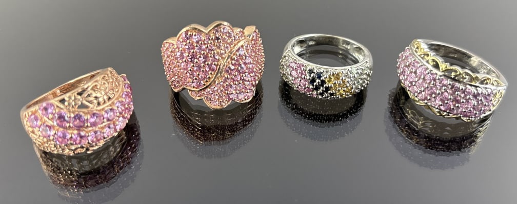 (4) 925 Sterling Silver Rings featuring Gemstones. Toal Weight: 26.34 grams.: (4) 925 sterling silver rings featuring gemstones. Sizes 9 and 7. The first ring features rows of circle-cut pink gemstones accented by a gold-toned design on the band. The second ring features green,
