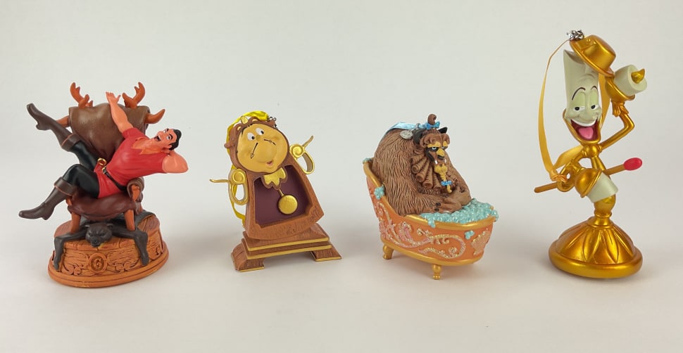 (4) Beauty and The Beast Ornaments: (4) Beauty and The Beast ornaments including Light up Lumiere ornament, 2018 Disney Store Cogsworth ornament, 2017 Beast Sketchbook Ornament, and Gaston Singing Sketchbook ornament,