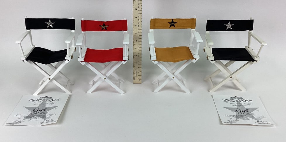Gene Doll Director Chairs: Gene Doll Director Chairs including two Gene's Director's Chairs, one Madra director chair, and one Trent Osborne Director's chair. Gene's Director's Chairs include COAs.