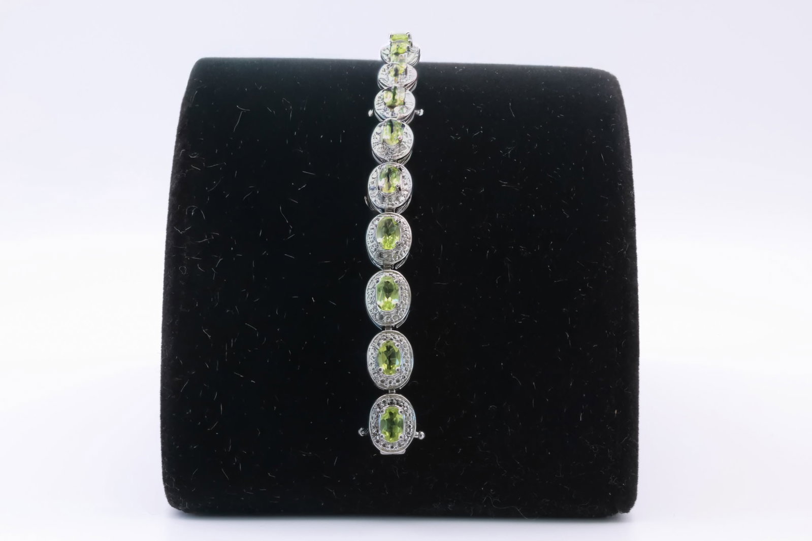 Peridot Sterling Bracelet: Peridot Sterling Bracelet featuring oval-cut, green peridot stones. TW: 12.03 grams. Approx. 6.5" long unclasped