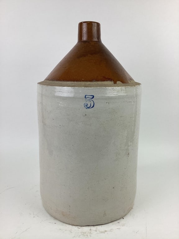 Cream and Brown Stoneware Crock Jug: Cream and Brown Colored stoneware crock jug marked #5. Measures approx. 20" tall with a diameter of approx. 2".