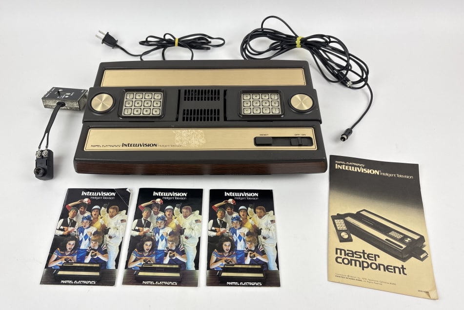 Mattel Electronic Intellivision: Mattel Electronic Intellivision Intelligent Television, Md 2609, includes master component, 2 non-detachable hand controllers, antenna switch box, Switch box cable, instruction booklet, game booklets.