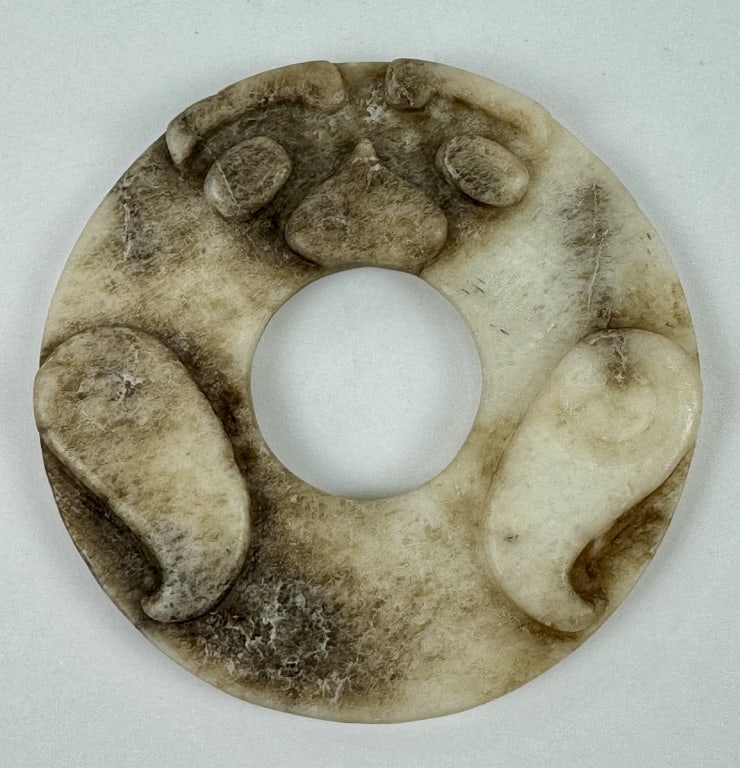 Archaistic Chinese Carved Chicken Bone Jade Bi Disk: Archaistic Chinese Liangzhu culture carved chicken bone bi disk. 3-1/4 inches diameter. 77.44 grams.