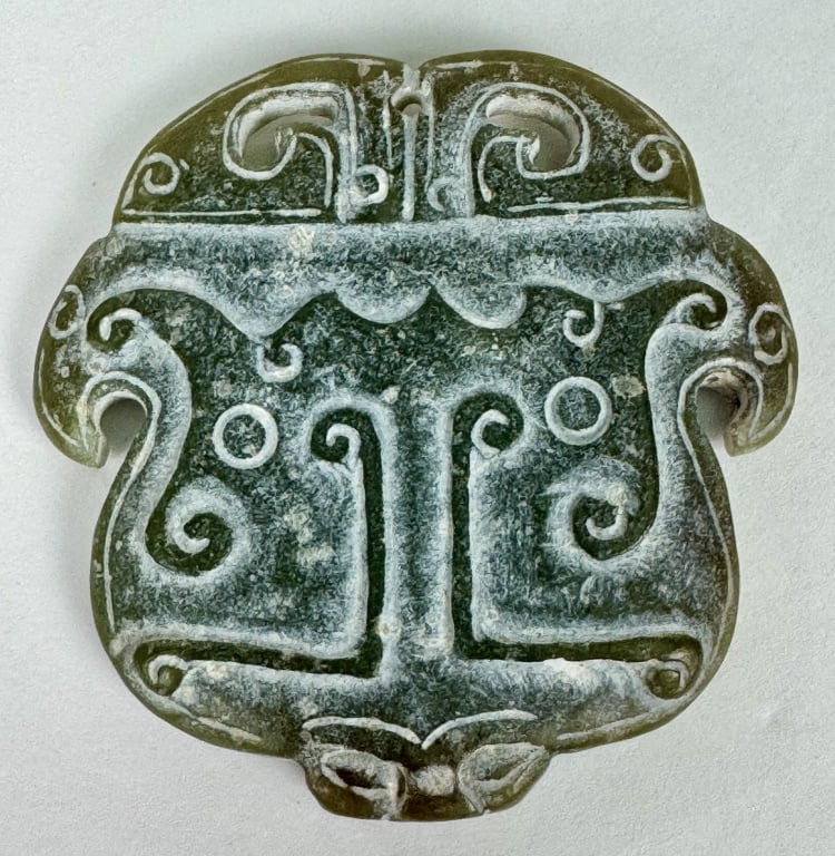 Archaistic Chinese Carved Celadon Jade Taotie Pendant: Archaistic Chinese Celadon Jade Taotie Carving. 2-1/4 inches x 2-1/4 inches. 40.13 grams.