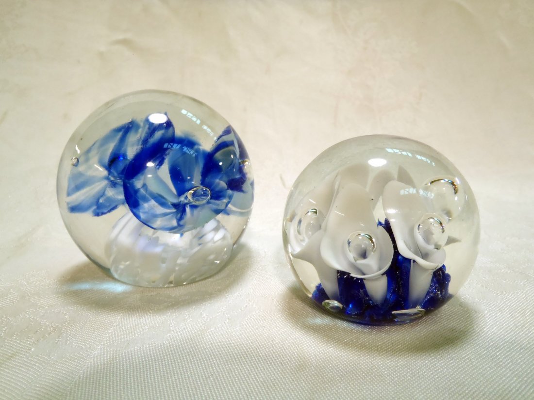 Two St. Clair art glass paperweights: Two St. Clair art glass paperweights White with blue flowers is stamped Tom St. Clair Studio Glass. Blue with white flower is stamped Joe St. Clair. Shipping rate B.