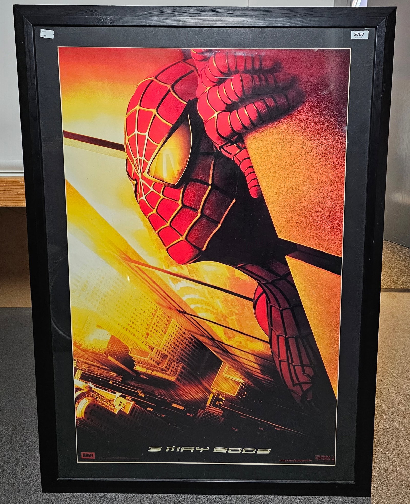 An original 2001 Spiderman 'Twin Towers' vinyl framed teaser movie banner, 96cm x 60cm (please: An original 2001 Spiderman 'Twin Towers' vinyl framed teaser movie banner, 96cm x 60cm (please note the mount appears to cover part of the poster, so the actual size of the poster is larger). 