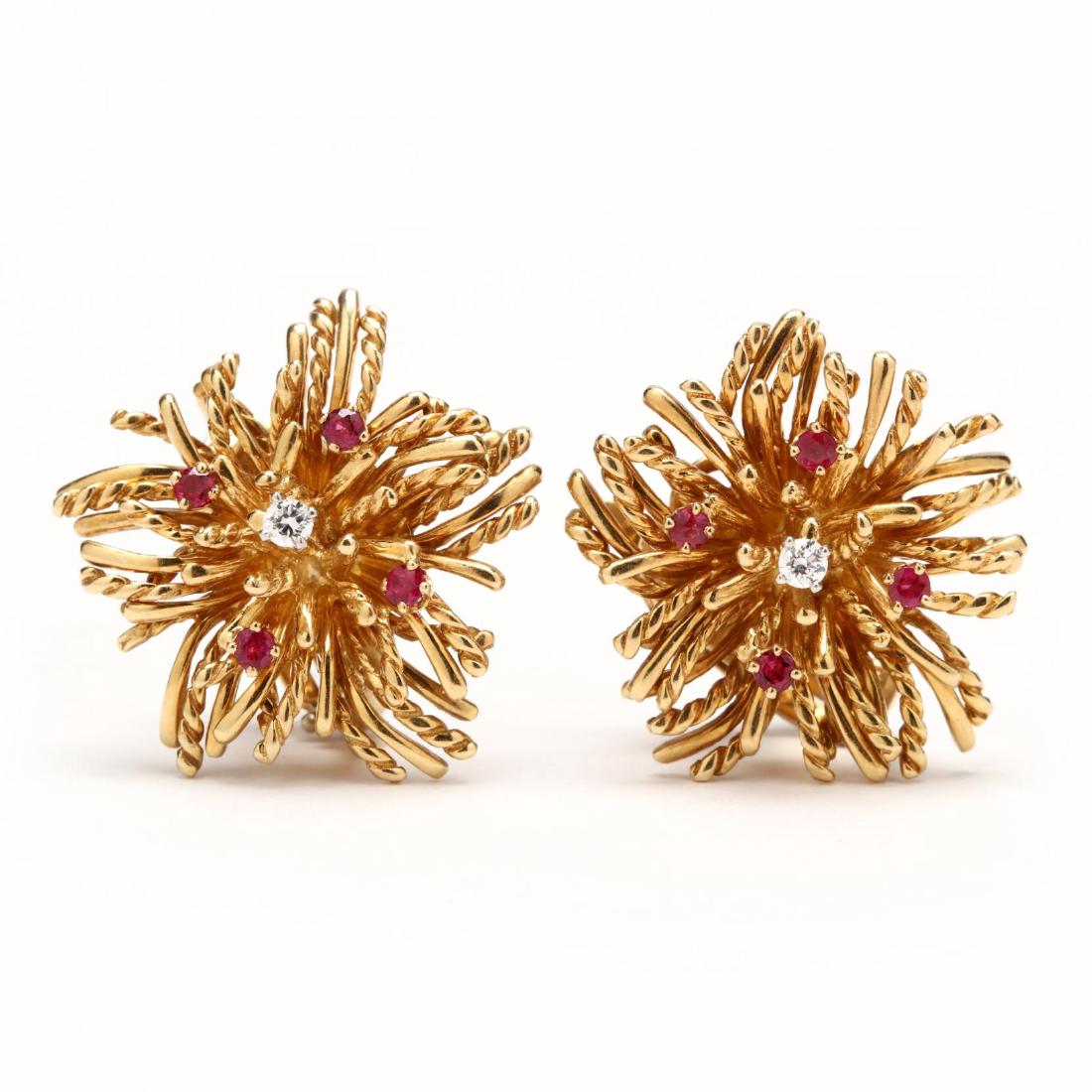 18KT Gold, Ruby and Diamond Earrings, McTeigue for: designed in yellow gold in a floral motif and each with one prong set round brilliant cut diamond (2.5mm) and (4) prong set round faceted cut rubies (2.0mm) completed with clip backs, signed Tiffany &