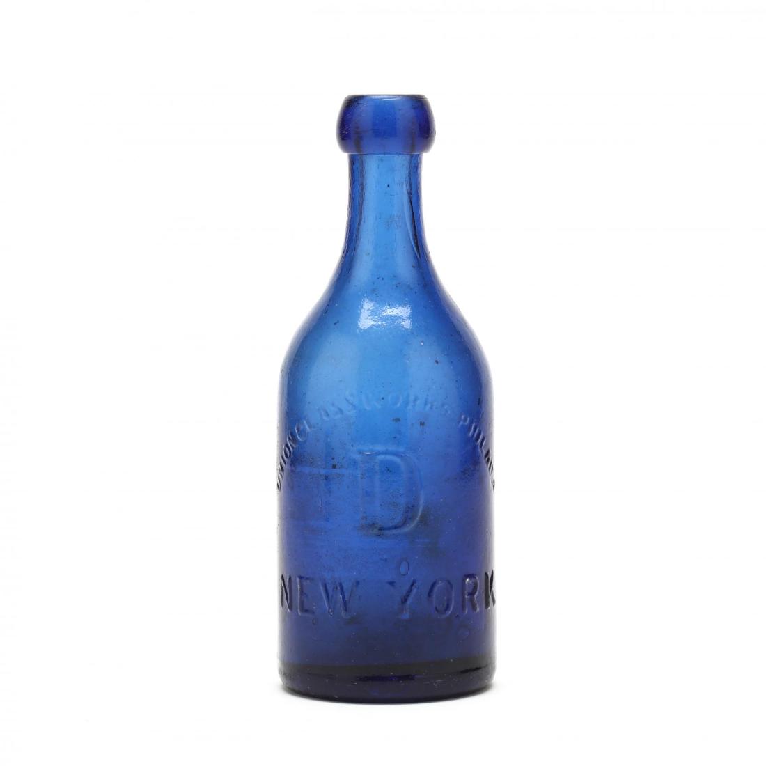 19th Century J&A Dearborn Bottle: cobalt blue, embossed body, mold blown, one side marked "J&A Dearborn N.Y.," the other side marked "Union Glassworks Philada/ D / New York." 7.25 in. Collection of Mr. and Mrs. Ray Henderson, New Bern