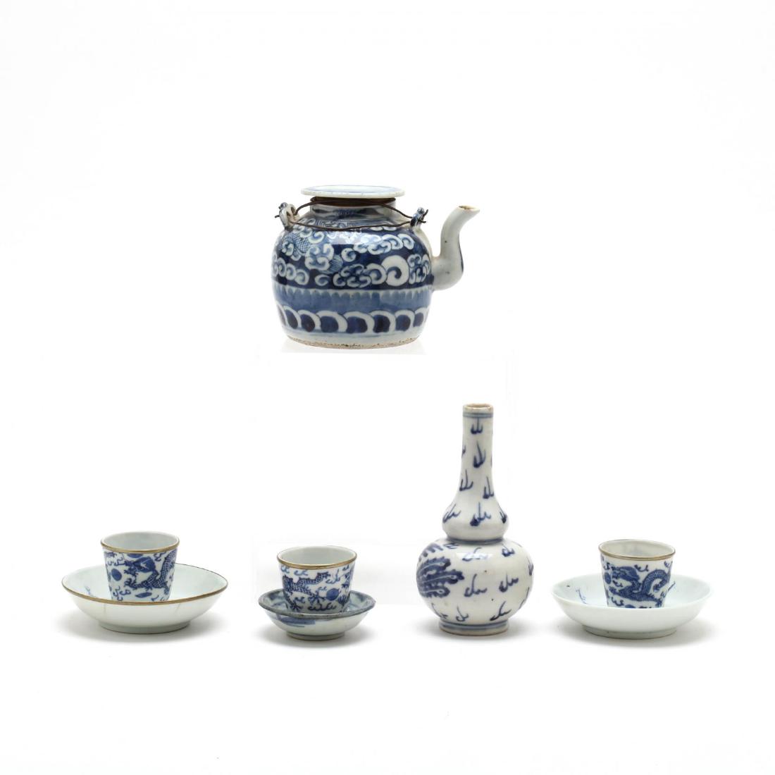 A Group of Antique Chinese Blue & White Porcelains: including a small wine pot with cover and metal handles (4 in.) (old shallow flake to underside of cover, minor roughness to spout); a set of three cups with metal rims and four character marks to und
