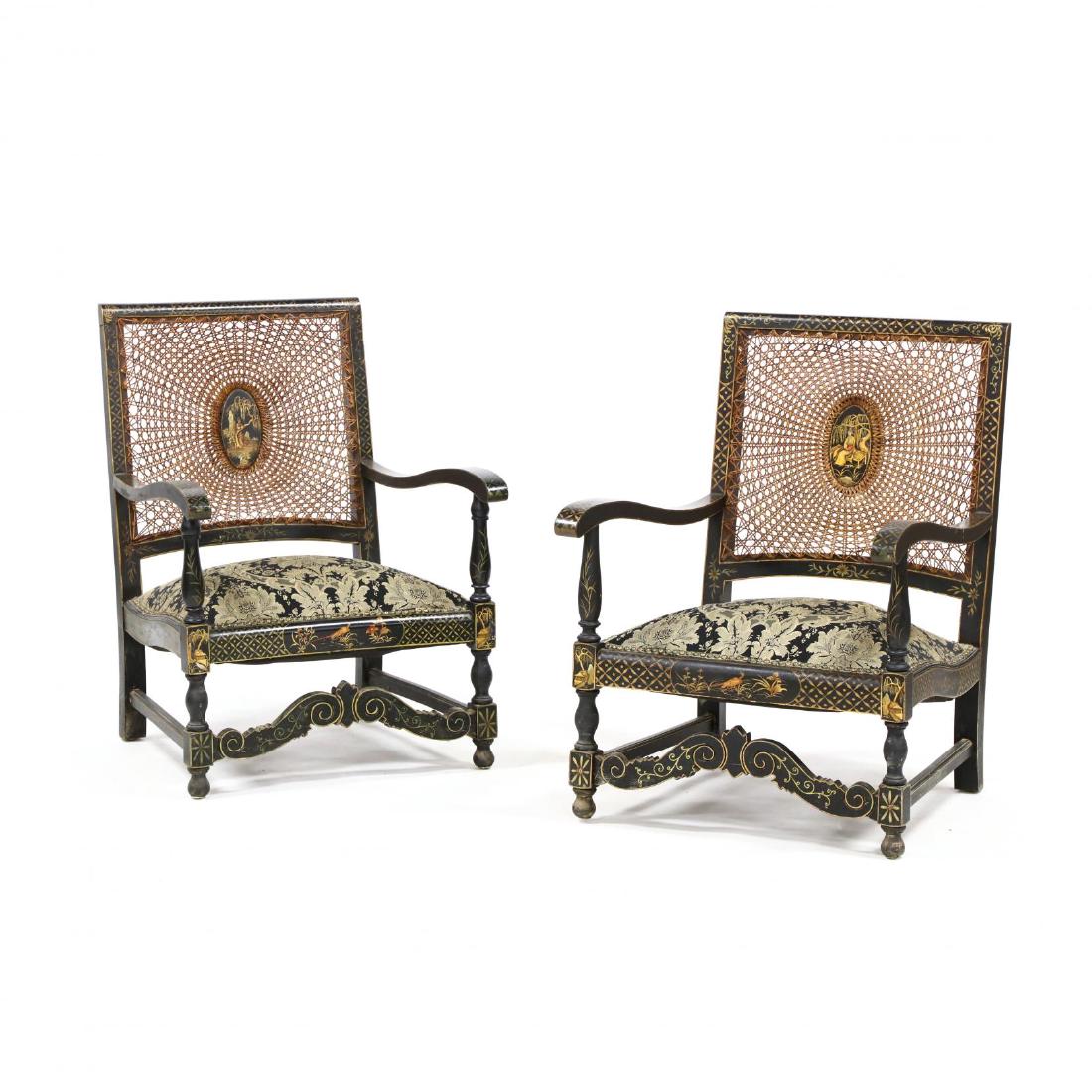 Pair of Chinoiserie Decorated Arm Chairs: early 20th century, cane backs, upholstered seats with nail head trim, scrolled stretcher on turned legs, featuring an all over painted and gilt decoration. 33.5 x 23.5 x 25.5 in. Additional high-reso