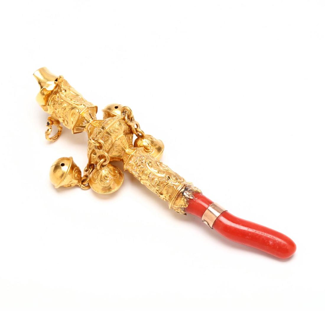 Rare Antique 18KT Gold and Coral Rattle, Whistle, and: with a whistle surmount, shaft with scrolled, flora, and foliate design elements suspending four bell form rattling balls, with curved red coral teether with a rose gold band, with hallmark and maker'
