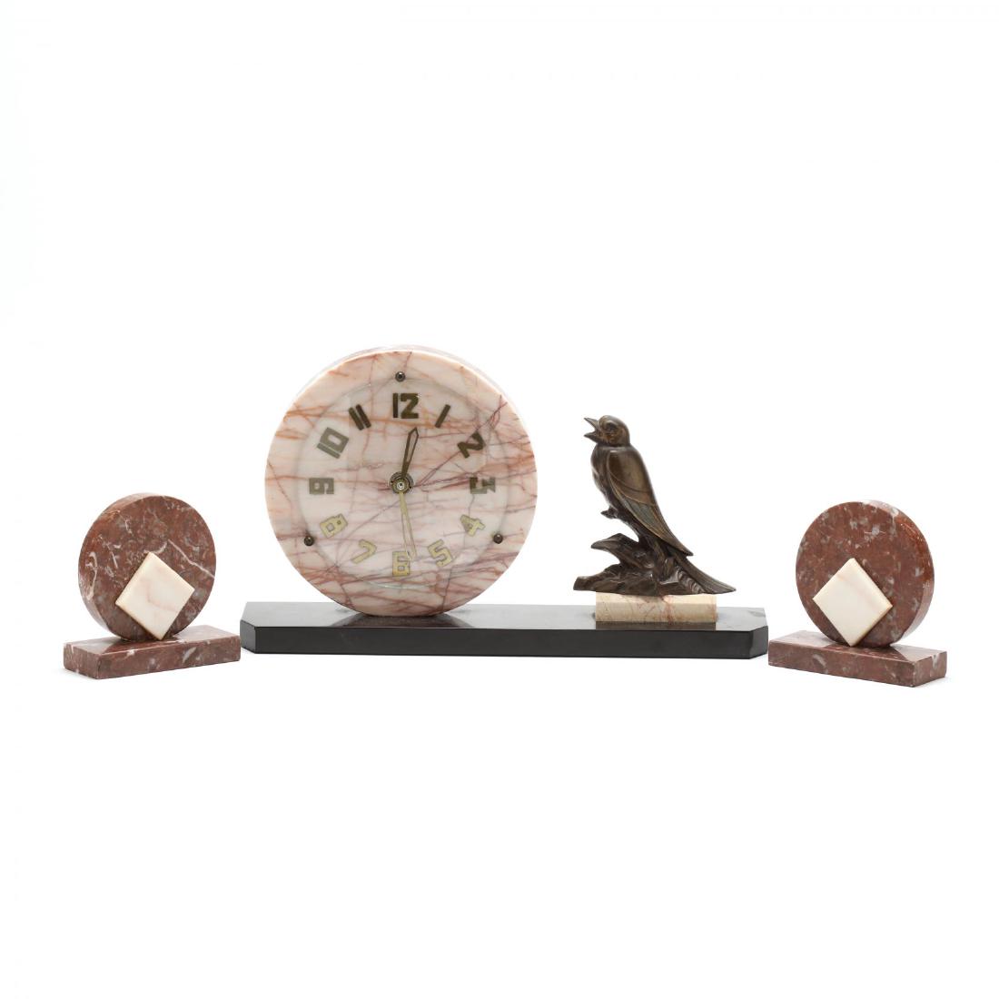 Art Deco Marble Clock Garniture Set: 1930s, mixed stones, gilt metal numerals with glass cover, the clock set with gilt bird. Clock 9 x 16 x 4 in. Additional high-resolution photos are available at LelandLittle.com