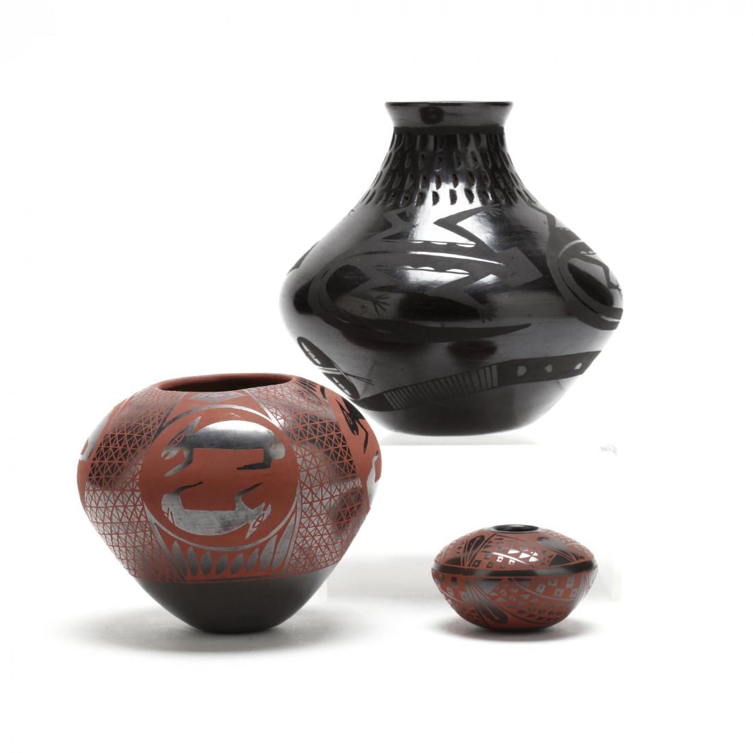 Mata Ortiz, Three Black Glazed Pottery Vessels: late 20th century, hand decorated, the tallest with tooled and lizard/snake decoration signed by David Ortiz, the second an ovoid form with rabbit motif with illegible signature and the third disc for