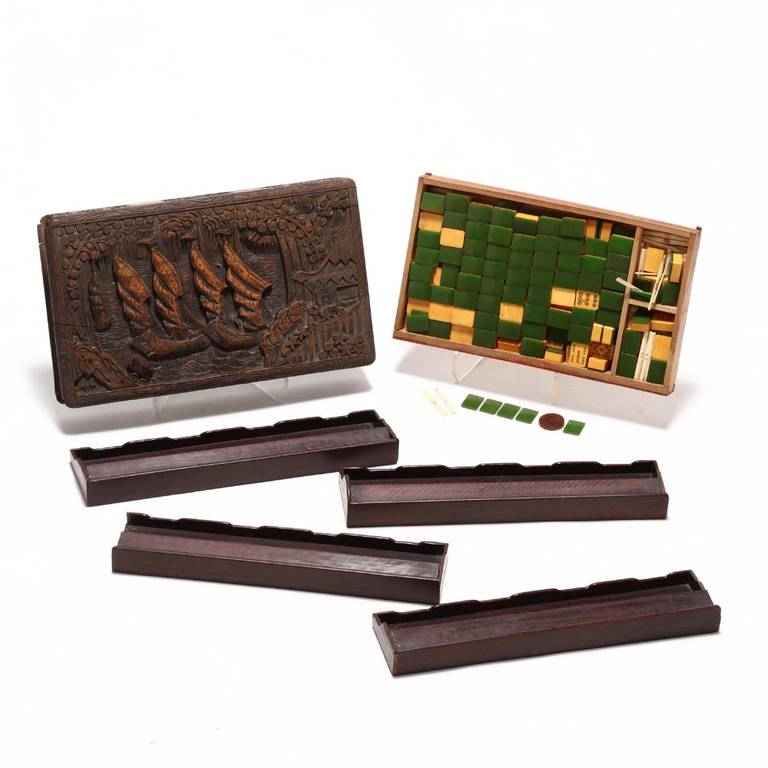 Vintage Mah Jong Set: early 20th century carved wood case with bone and bakelite tiles, together with four 19th century carved hardwood tile trays. Case 3 x 16 x 9 in. Additional high-resolution photos are available at Lel