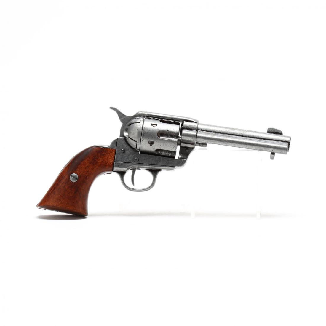 Movie Prop Revolver: 20th century cast metal and wood revolver. 11 in. long. The gun was purportedly purchased in Wilmington as a used film prop. Additional high-resolution photos are available at LelandLittle.com
