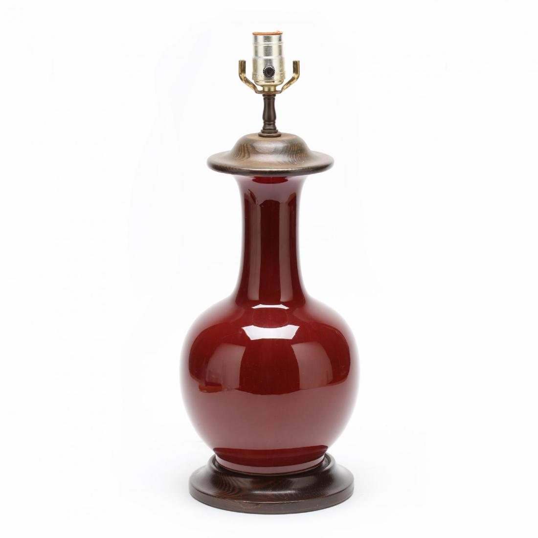 Chinese Sang de Boeuf Porcelain Table Lamp: early 20th century, bulbous form, wood mounts, with shade. Porcelain height 13 in. From the Collection of Esther B. Ferguson, Secessionville Manor, Charleston, SC Additional high-resolution photos are