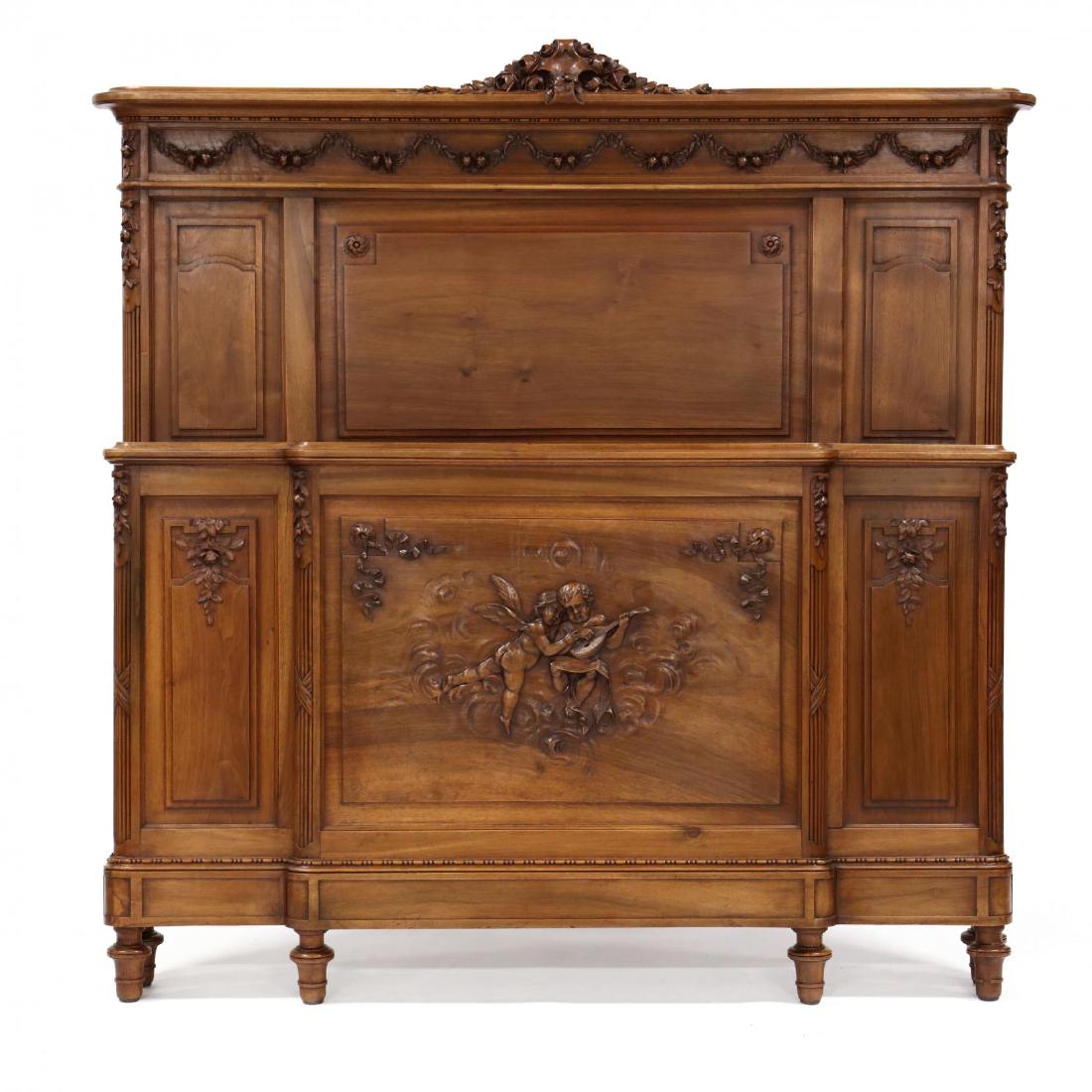 Louis XVI Style Carved Walnut Bed: circa 1890, paneled head board and foot board with relief carved decoration of floral swags and putti, raised on short turned legs, with original wood rails and bolts, together with a pair of later cu