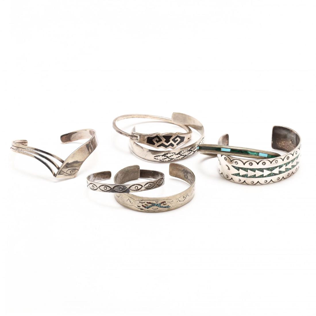 Seven Native American Cuff Bracelets: silver, some with inlaid stones. 4.355 Total Troy oz. The Native American Collection of Mr. Wayne Lockey of Grand Junction, Colorado. Additional high-resolution photos are available at LelandLittle.co