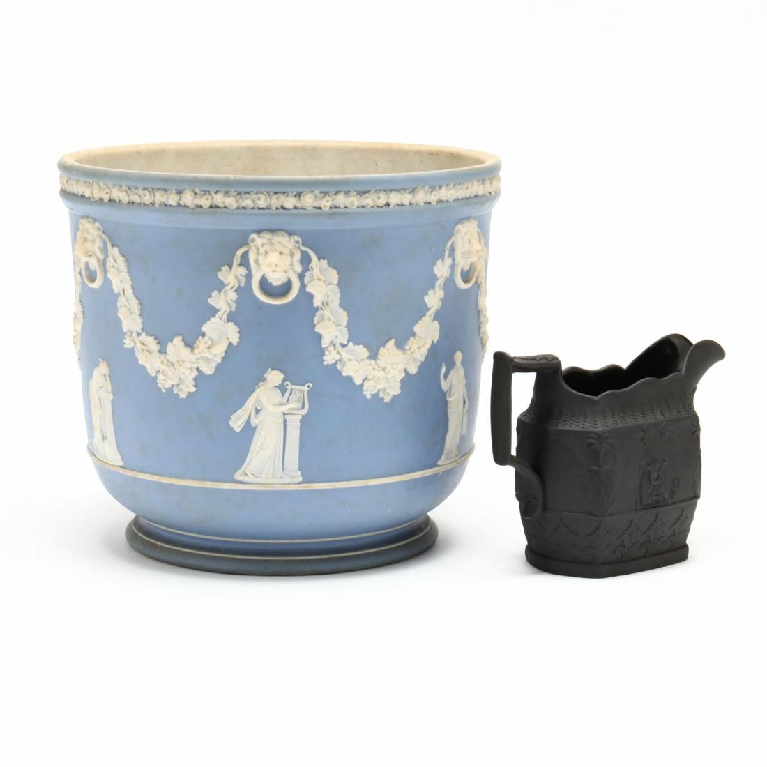 Two Pieces of Jasperware: a Wedgwood footed jardiniere, classical decoration over matte light blue body; an unmarked basalt cream jug. Jardinere 7 1/8 x 8 1/8 in. The Lifelong Collection of Keith and Caroline Gray, Charlotte,