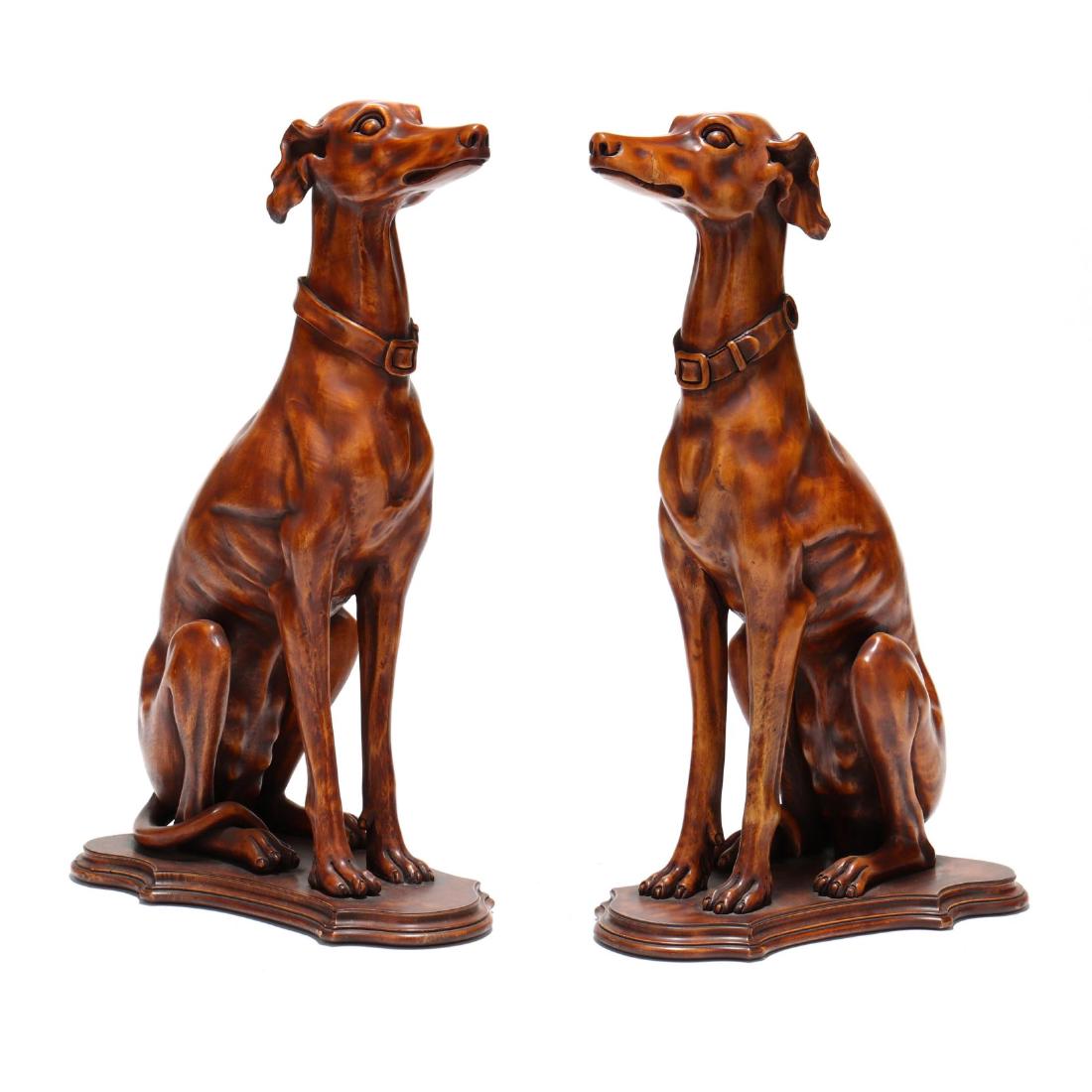 Pair of Carved Wood Hounds: late 20th century, carved wood with ochre lacquered and antiqued finish, each attentive dog mounted to a shaped and molded plinth. 31 x 18 x 11 in. From The Collection of the Late Stuart Walston and D
