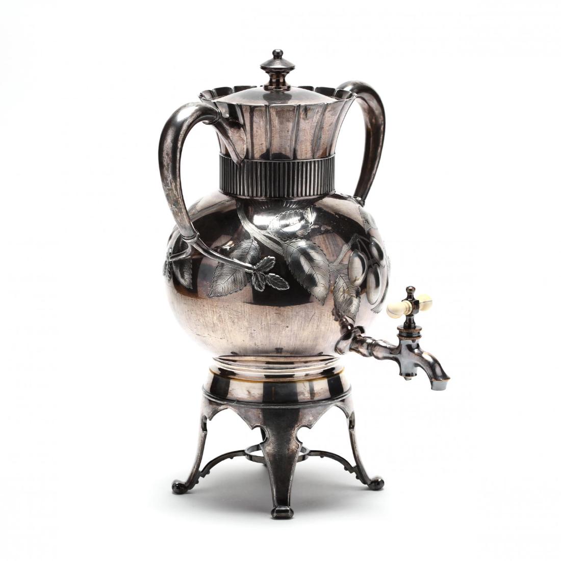 An Aesthetic Period Silverplate Tea Urn: mark of Meriden Britannia Co., circa 1870, with cherry branch and blossom decoration, removable cover, lacking burner. 15 in. From The Collection of the Late Stuart Walston and Doris Schaum Walston of