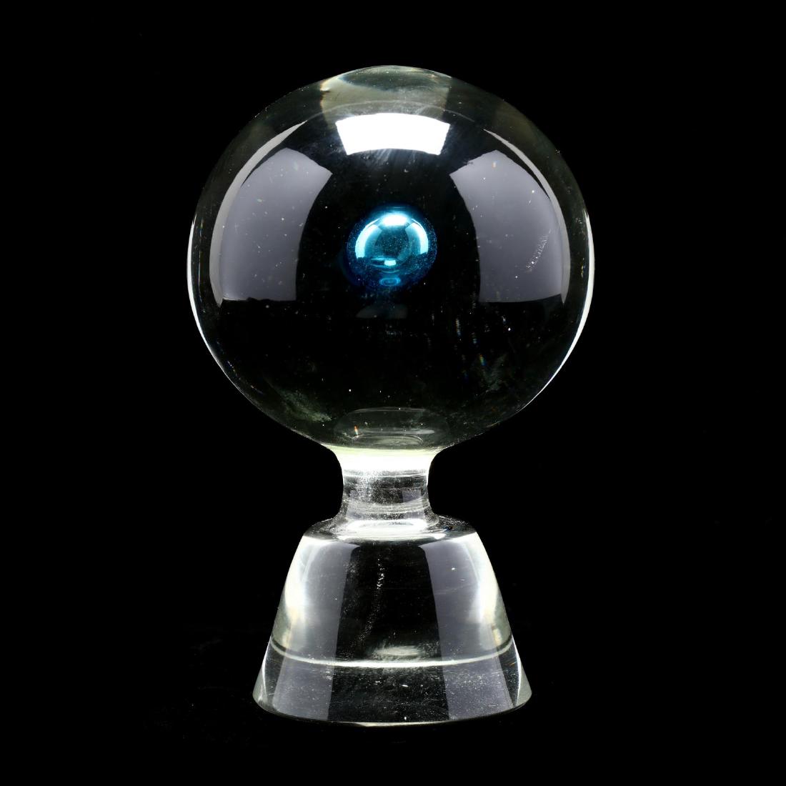 Vintage Art Glass Newel Post: mid 20th century, clear glass orb with interior blue glass air trap on a tapered base, unmarked. 7.25 in. From The Collection of the Late Stuart Walston and Doris Schaum Walston of Wilson, North Carol