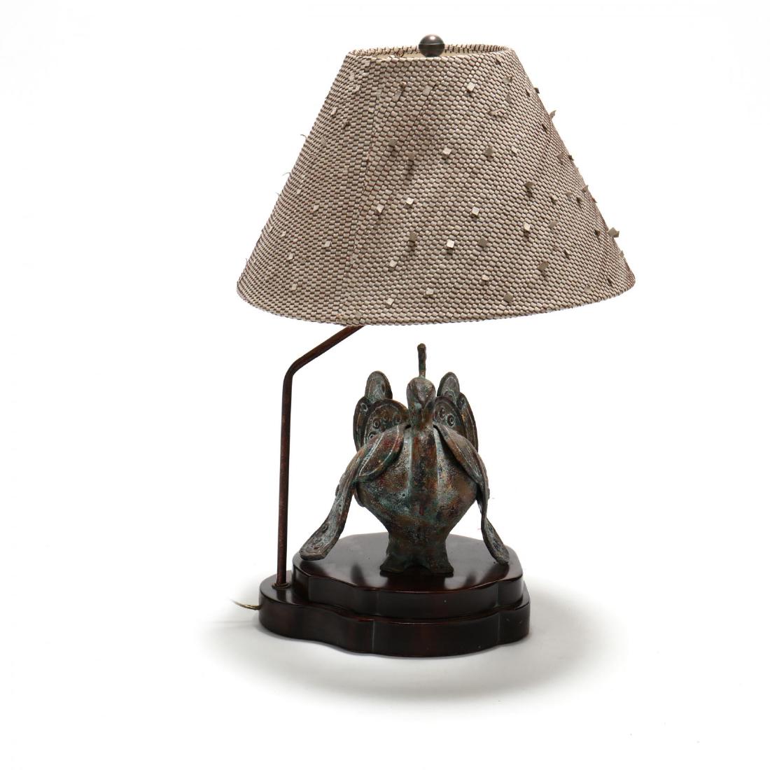 Frederick Cooper, Archaic Style Table Lamp: late 20th century, metal bird form censer with antiqued surface on wood stand, woven leather shade, labeled. HOA 24 in. Additional high-resolution photos are available at LelandLittle.com