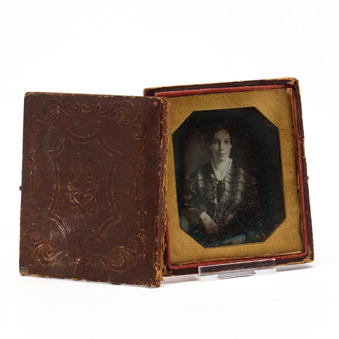 Identified Sixth Plate Daguerreotype of a Comely Young: 1840s, presented in a case behind a simple octagonal mat, the sitter is named in the following letter from Salt Lake City penned in 1912: "Dear Claude this picture is for my Godson when he grows up. I
