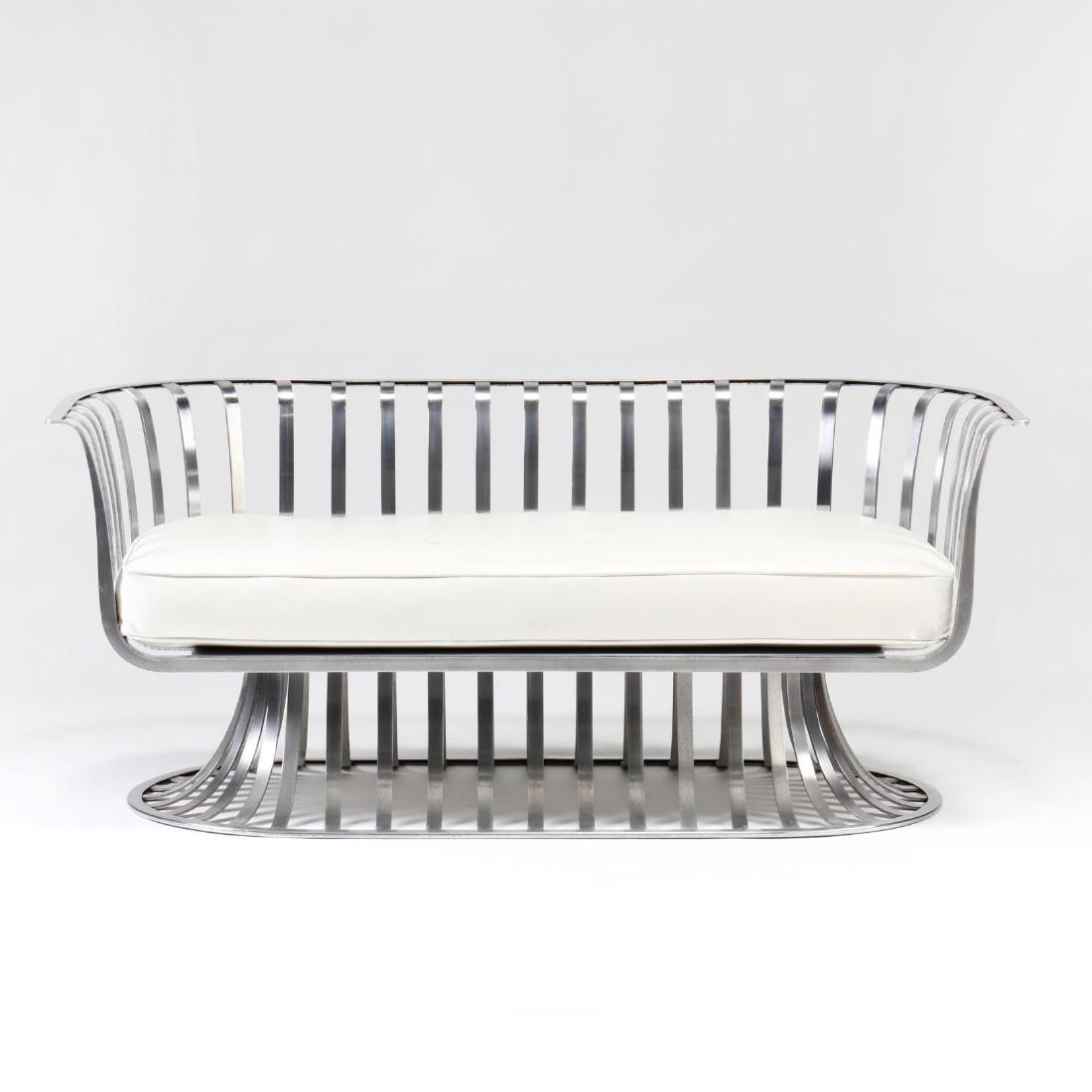 Russell Woodard, Aluminum Settee: 1960s, shaped slat form, with later white leather upholstered seat cushion, unmarked. 26.5 x 62 x 29 in. Additional high-resolution photos are available at LelandLittle.com