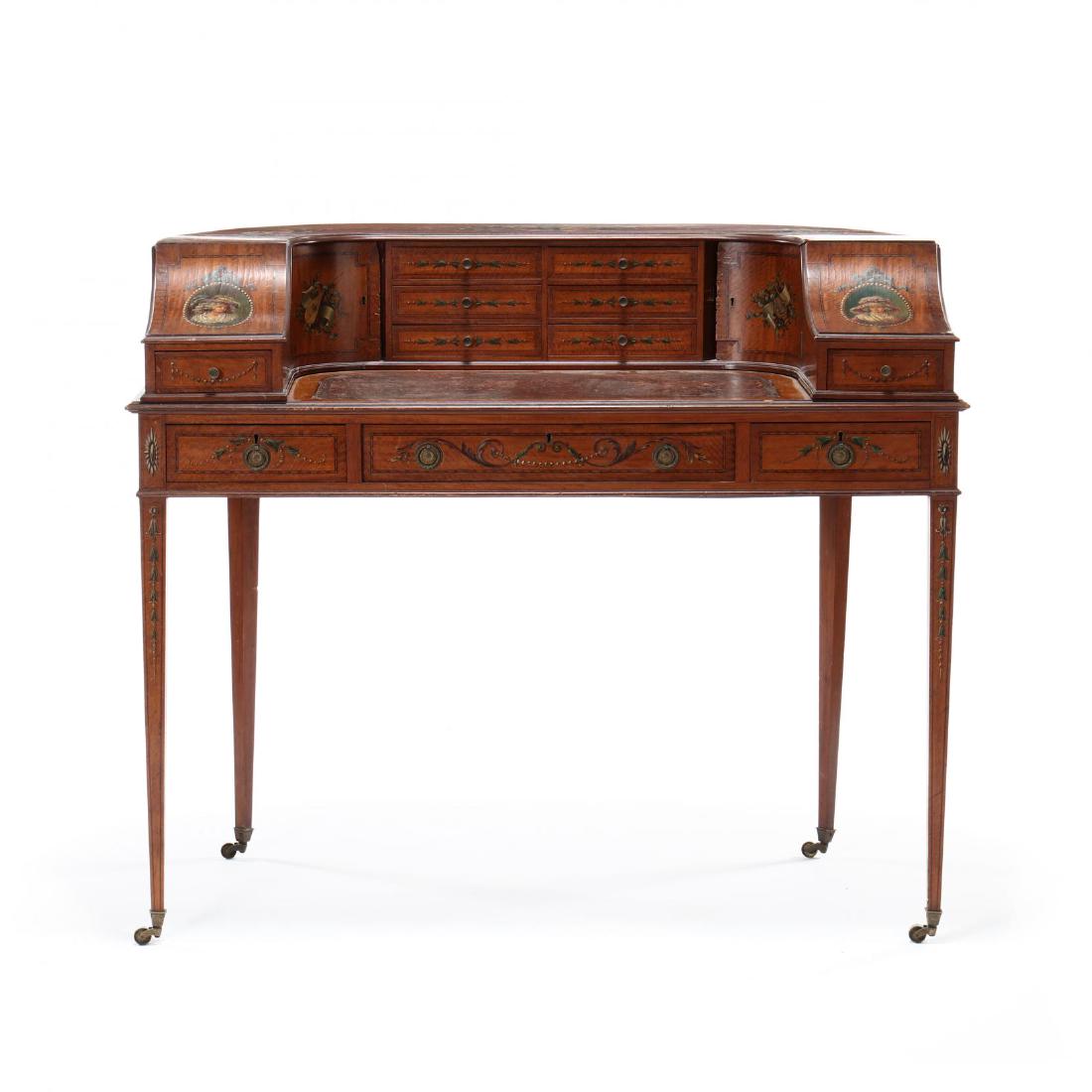 Adams Style Carlton House Writing Desk: circa 1890, satin wood with mixed wood inlays, mahogany secondary, one part form, 'U' shaped cabinet with allover painted floral sprays, ribbon, portraits and musical vignettes, upper case with six ce
