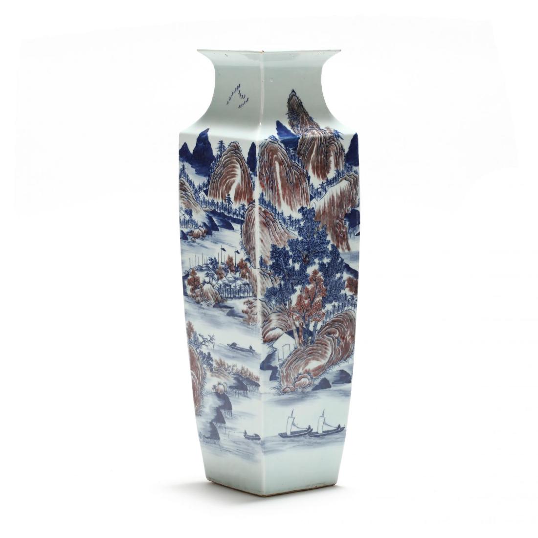 A Tall Chinese Copper Red and Blue Porcelain Celadon: Qing dynasty (1644-1911), 19th century or earlier, decorated with copper red and blue with a light celadon ground, a tapered square baluster vase with flared neck over square shoulders, decorated with