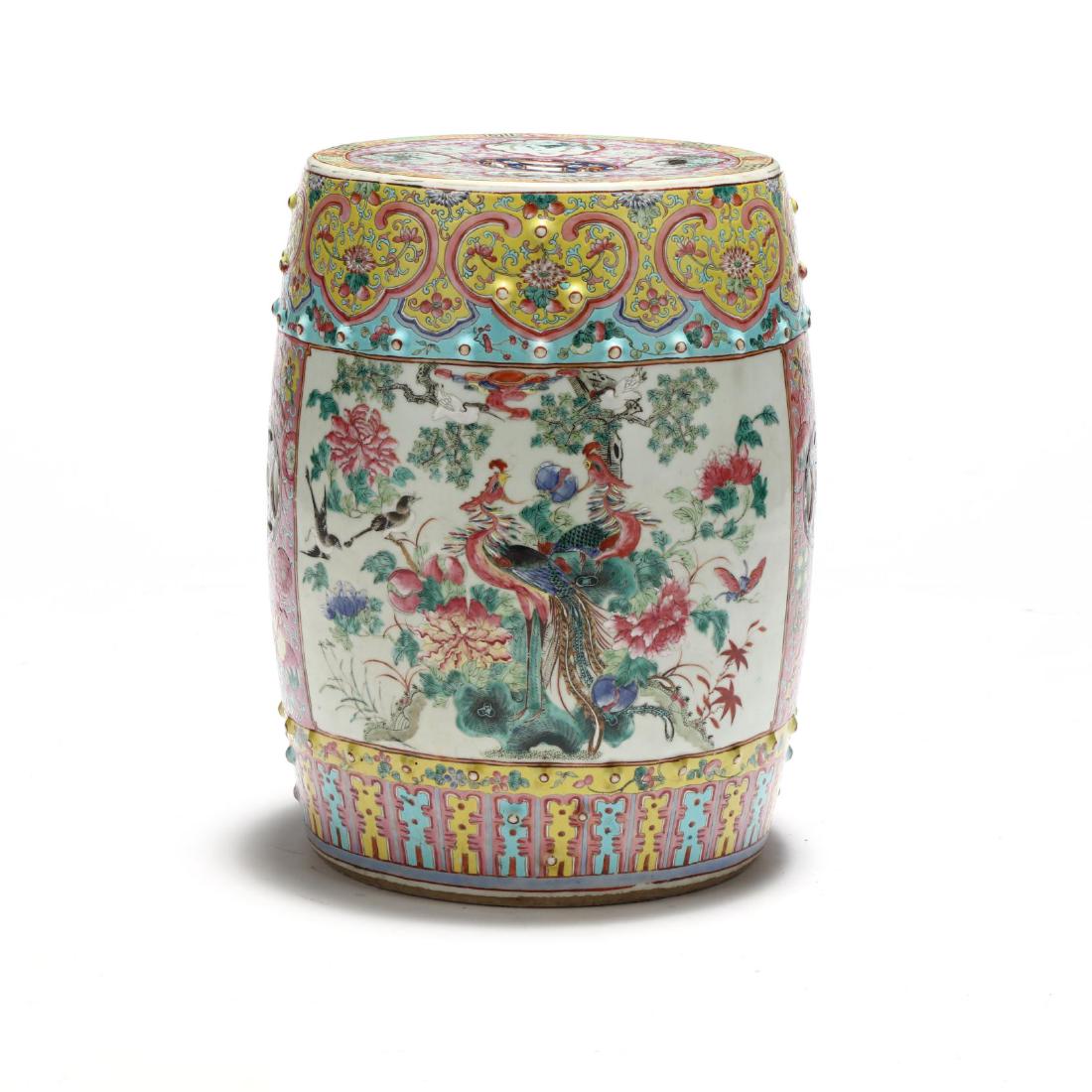 A Chinese Famille Rose Drum Garden Stool: Qing dynasty (1644-1911), 19th century, the body of porcelain drum is elaborately decorated with auspicious symbols in vivid colors, a myriad of birds and lush flowers including a pair of peacocks on 