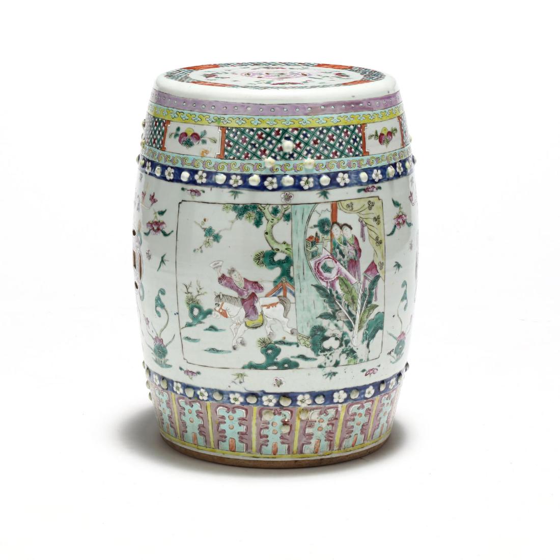 A Chinese Famille Rose Drum Garden Stool: late 19th or early 20th century, the body of the porcelain drum is decorated with two large registers with Chinese figures on outdoor terraces, between these two registers are double coins linked in p