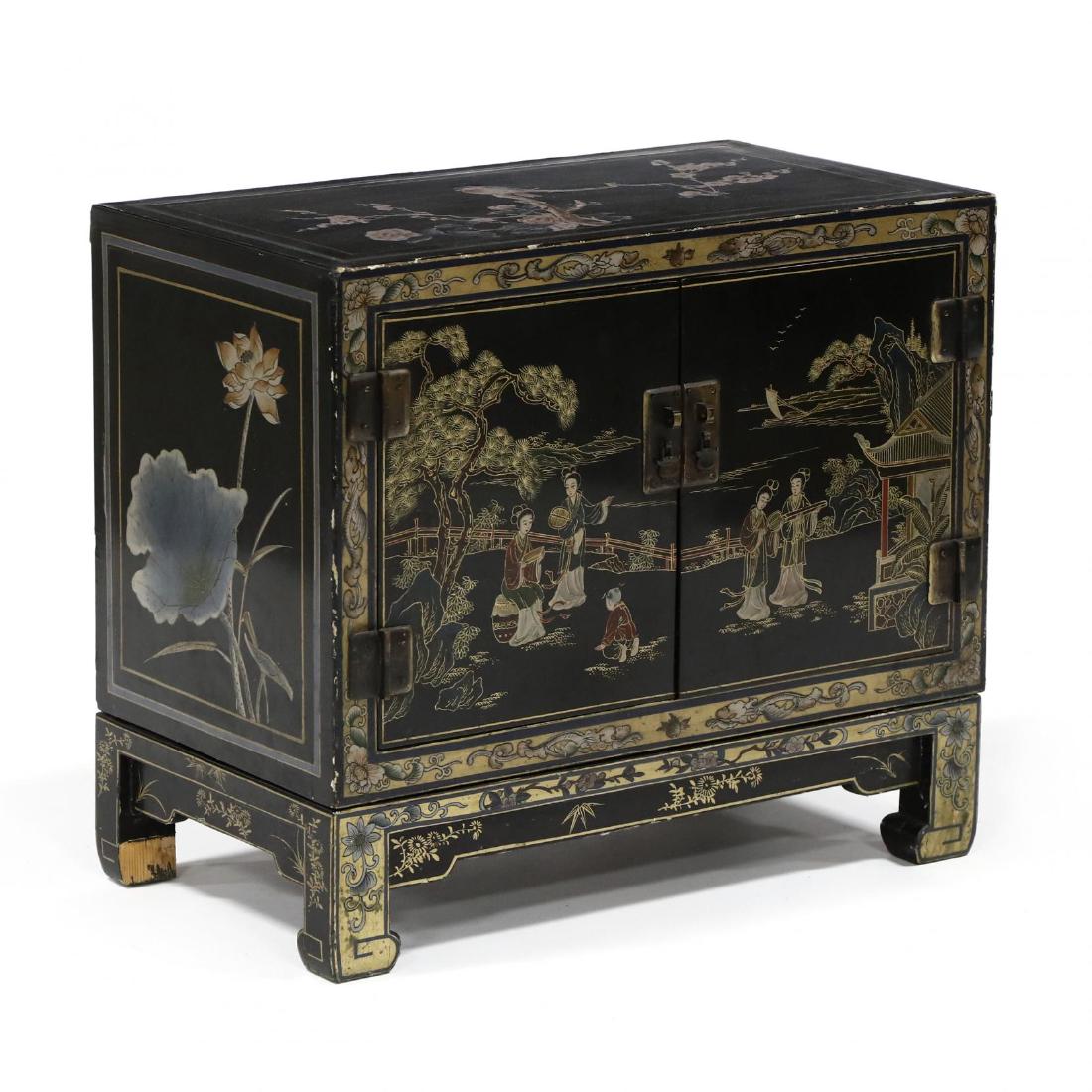 Chinese Lacquered Diminutive Cabinet on Stand: late 20th century, black field, hand painted with birds and figures, the cabinet with two hinged doors, open interior, on a fitted stand, labeled "Hong Kong." 20 x 23 x 13 in. Additional high-resolut
