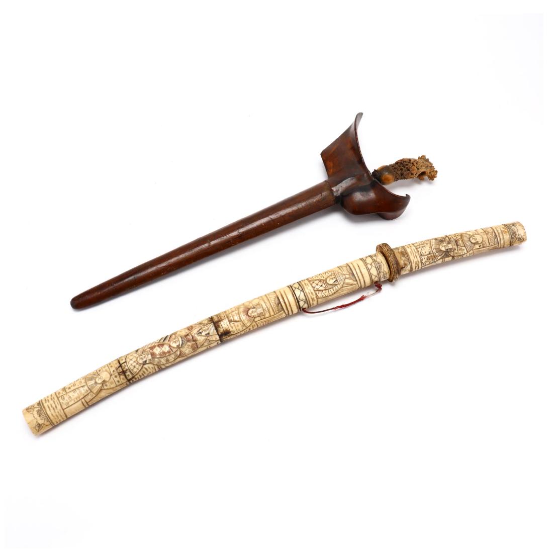 Two Antique Asian Knives: 19th century, including an Indonesian kris in wood sheath with carved bone handle; and a Japanese short sword in carved bone sheath. Longer 24 in. Additional high-resolution photos are available at Le
