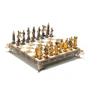 Giuseppe Vasari (Italian, 1934-2005), Gilt Metal: 32 game pieces, well cast and detailed bronze with gilt and silvered highlights, pieces depicting crusaders and Saracens, with corresponding alabaster and marble inlaid chess board with horse-form sup