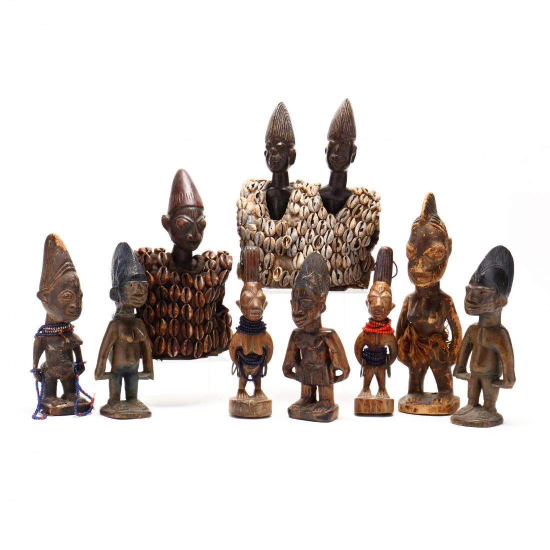 Yoruba Figural Effigies: three pairs of male-female twins, some with beads; a male pair wearing a cowrie shell vest; a single male with cowrie shell vest; single female with raffia. This lot to be sold on day 2, Thursday, Oct