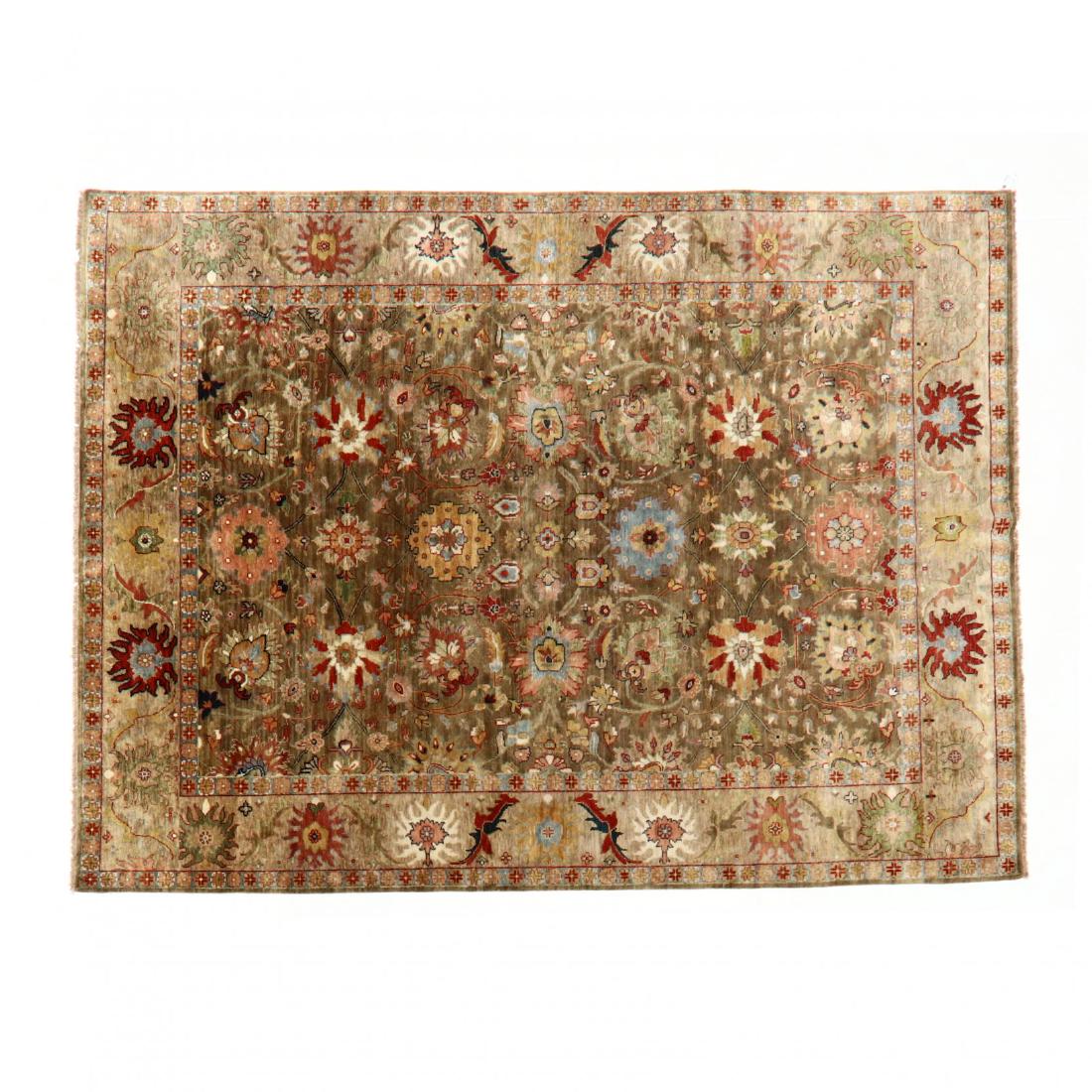 Indo Oushak Room Size Carpet (8 ft. 10 in. x 12 ft.): NOA Living, olive field with all over multi colored palmette and floral motif. This lot to be sold on day 2, Thursday, October 4 (Lots 949-2020) 8 ft. 10 in. x 12 ft. From the Complete and Important C