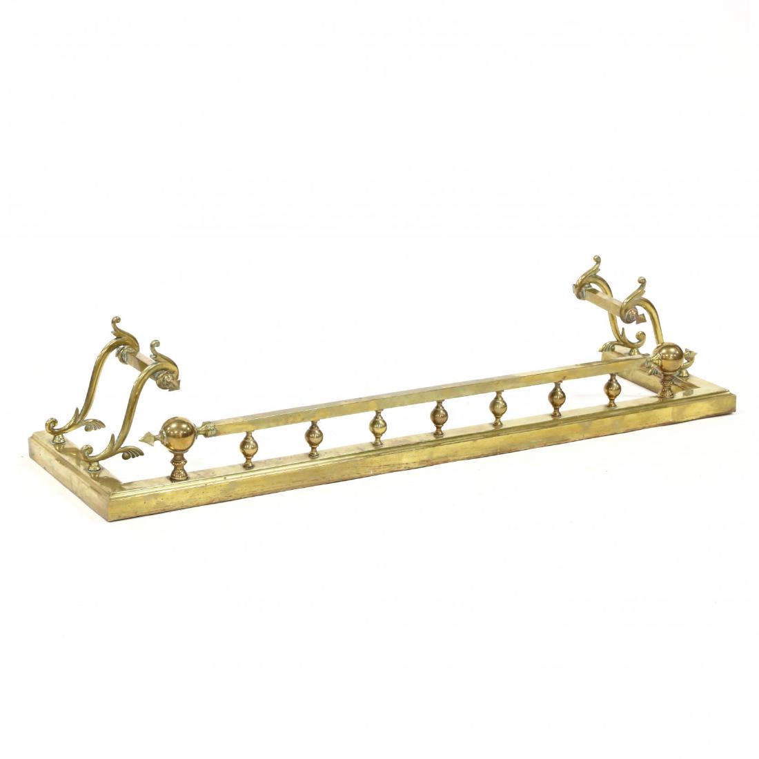 Neoclassical Style Brass Fire Fender: Neoclassical Style Brass Fire Fender mid 20th century, central bar with orb and spear ends with spindle supports flanked by scrolled arms with spear ends on a molded base. 10.5 x 53 x 14.5 in. Additio