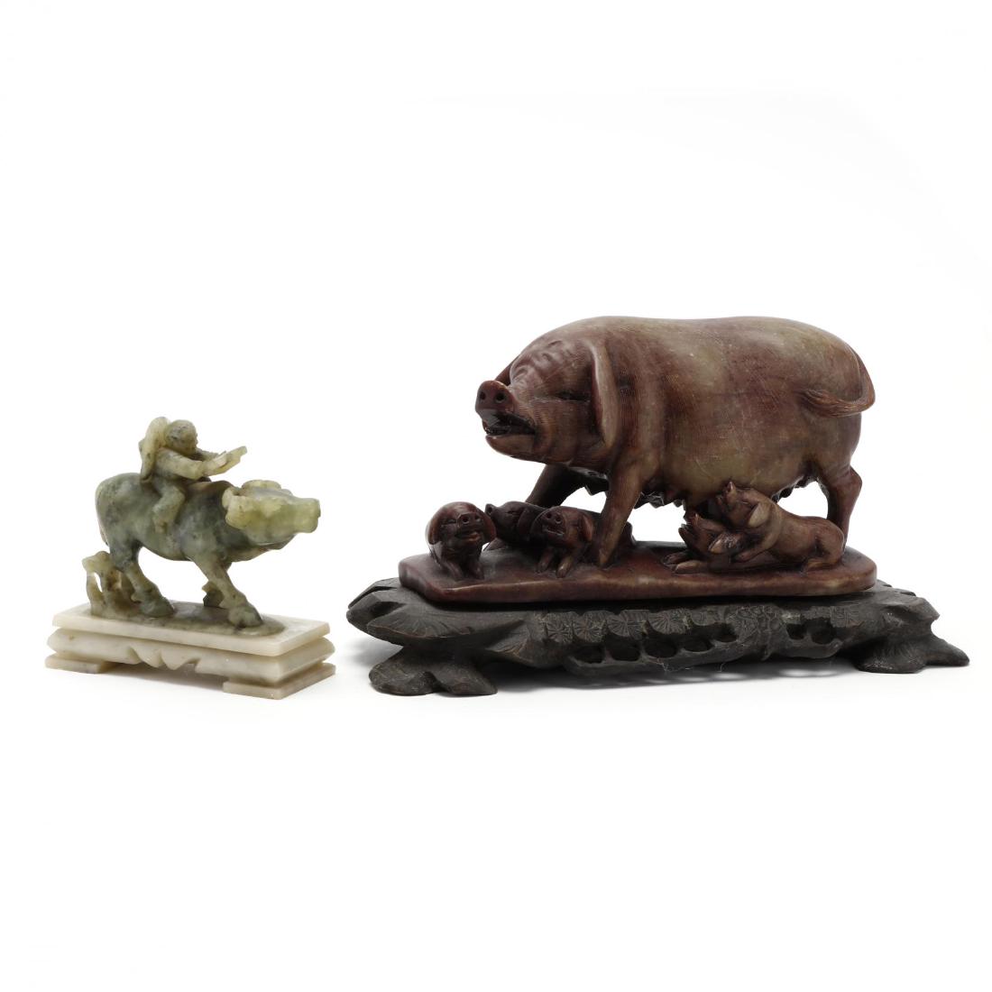 Two Chinese Stone Carvings: Two Chinese Stone CarvingsIncludes a carved and etched soapstone mother pig surrounded by her piglets on a carved wooden stand, and a Chinese carved spinach jade hardstone figure riding a water buffal