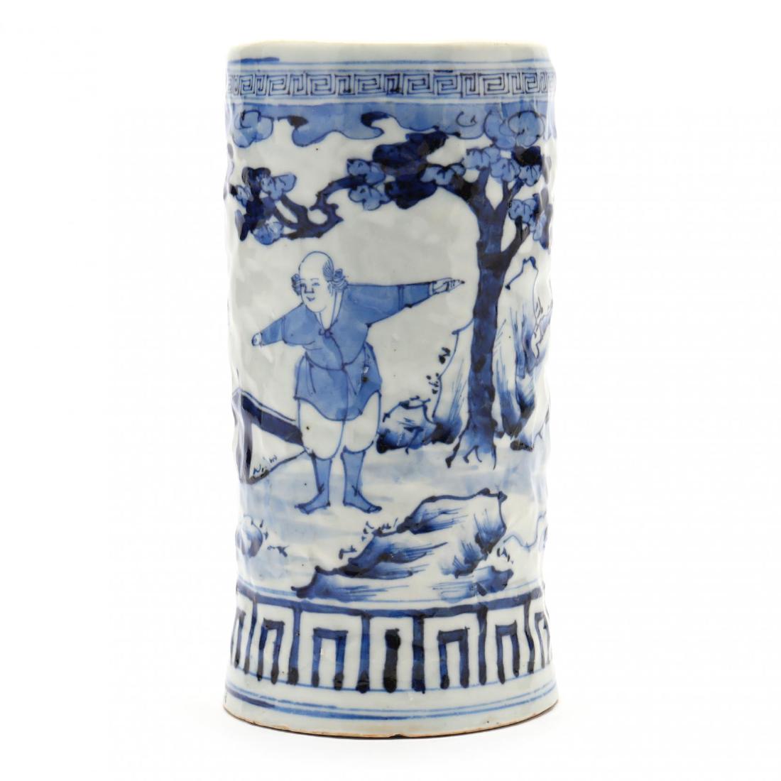 An Unusual Japanese Blue and White Porcelain Brush Pot: An Unusual Japanese Blue and White Porcelain Brush Pot with Foreigners Edo period (1615-1868), circa 1800, Arita ware, a mottled porcelain brush pot, unusual for its evidence of finger modeling throug