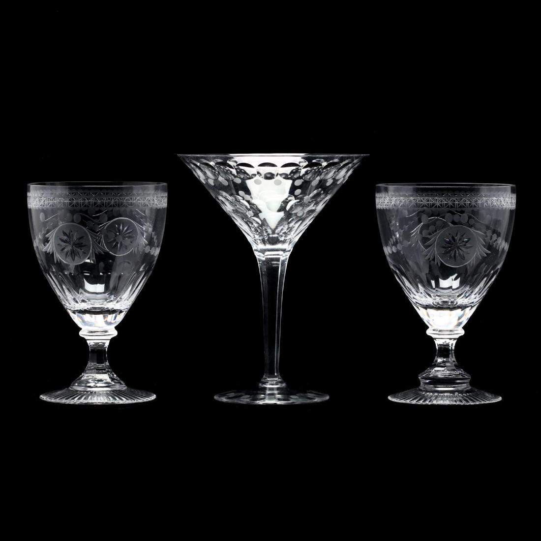 William Yeoward, Pair of Engraved Wine Goblets and: William Yeoward, Pair of Engraved Wine Goblets and Martini Stemcontemporary, the goblets with an Adams style star and bead decoration with star cut foot, together with a large dot pattern martini glas