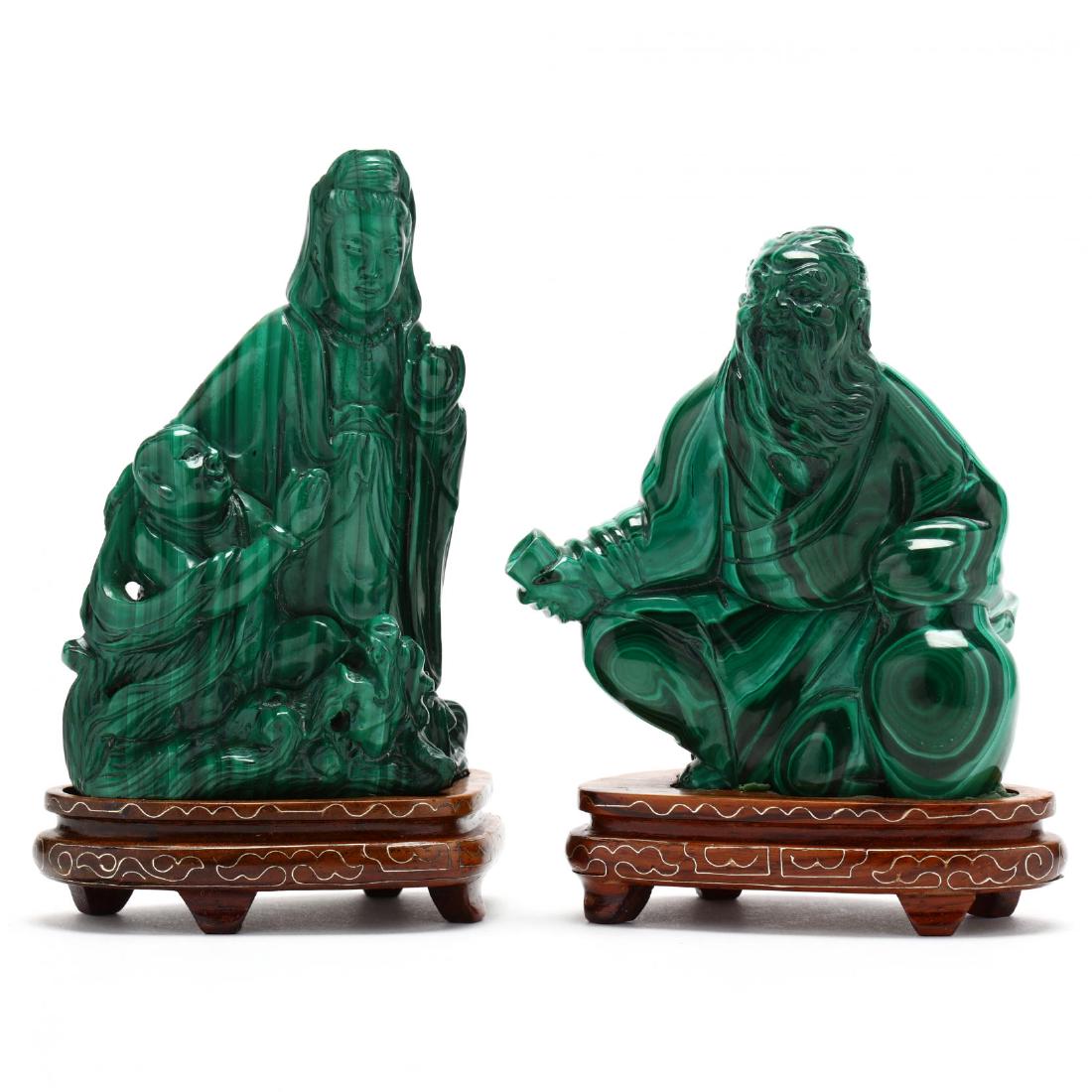 Two Chinese Carved Malachite Figures: Two Chinese Carved Malachite Figures20th century, the first in the form Kwan Yin with fruit and figure, the second of a seated elder with cup, each in custom hardwood stands. Taller 5 in. Collection o