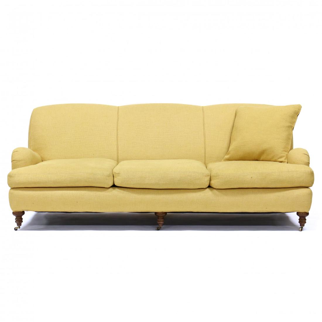 Lee Industries, English Style Over Upholstered Sofa: Lee Industries, English Style Over Upholstered Sofa late 20th century, yellow upholstery, triple panel back with loose down filled cushions and pillows, raised on turned wood legs with front casters, 