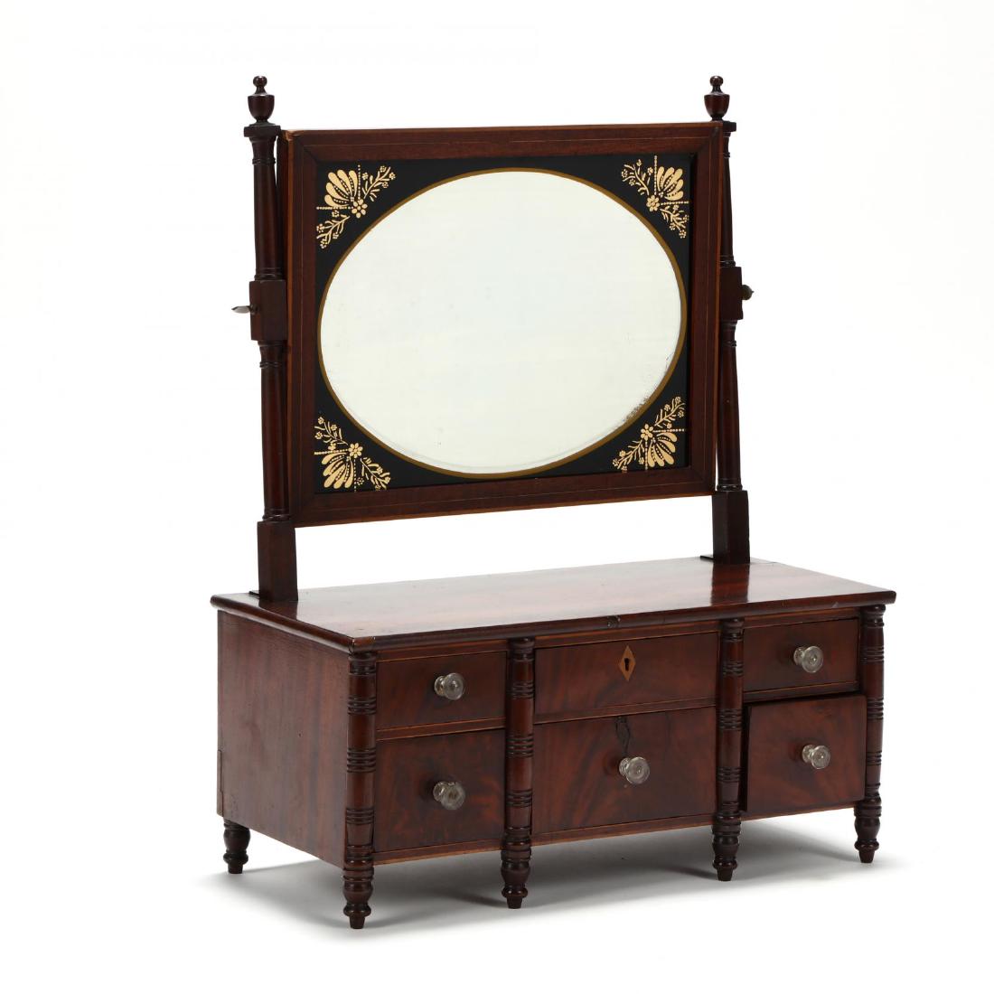 American Federal Mahogany Dressing Mirror: American Federal Mahogany Dressing Mirror circa 1800, pine secondary, hinged rectangular mirror with eglomise and gilt surround, frame with light line inlays, lower cabinet with six drawers on turned 