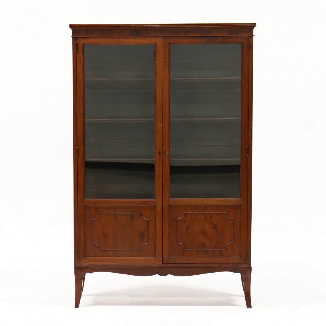 Edwardian Mahogany China Cabinet: Edwardian Mahogany China Cabinet labeled Sterne Brothers, New York, early 20th century, mahogany, one-part form, two hinged glazed doors, with shelved interior, on splayed feet, labeled. 62 x 40 x 15 