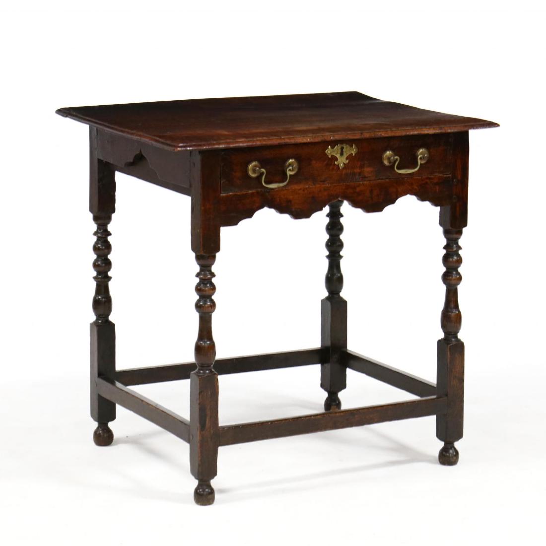 English Jacobean Oak Writing Table: English Jacobean Oak Writing Table 18th century, oak secondary, rectangular top with molded edge, single flush mount drawer, shaped skirt, baluster and ring turned legs, on stretcher base. 29 x 30 x 2