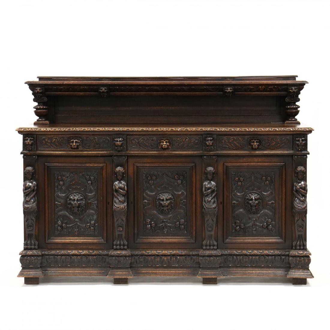 Renaissance Revival Carved Oak Buffet: Renaissance Revival Carved Oak Buffet circa 1890, removable backsplash shelf with lion mask and columnar supports, case with three relief carved drawers featuring lion mask pulls over three hinged cab