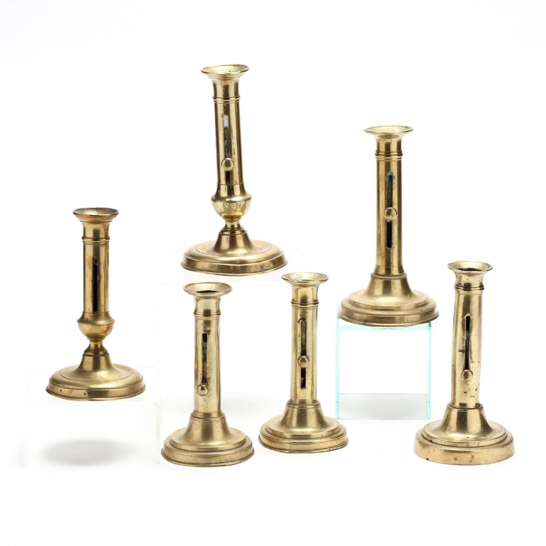 Six Antique Brass Push-Up Candlesticks: Six Antique Brass Push-Up Candlesticks 19th century, each with circular stepped foot. Tallest 8.25 in. The Estate of the late Rushton W. Hays, St. Augustine, FL Additional high-resolution photos are a