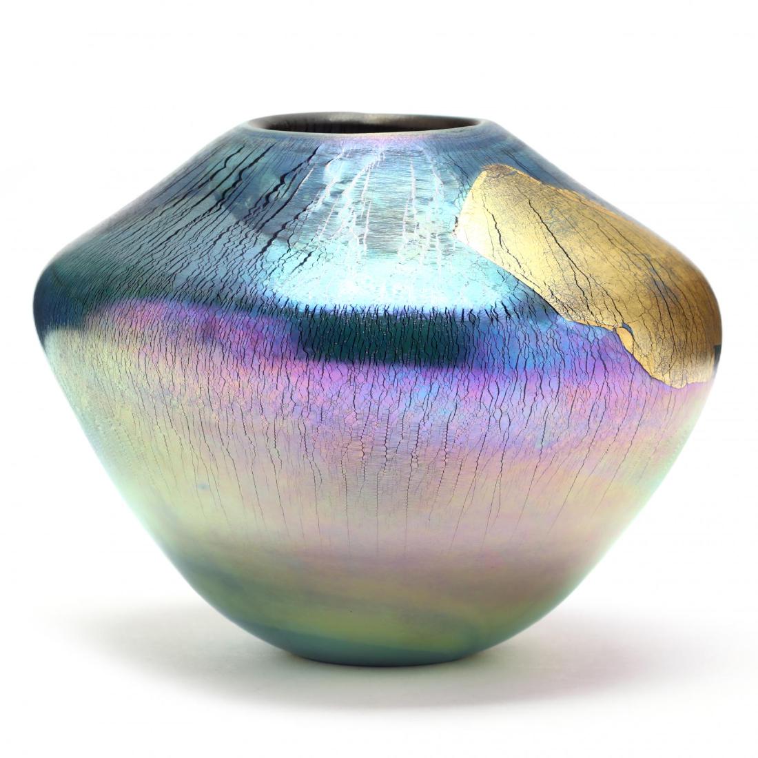 Eickholt, Memphis Style Art Glass Vase: Eickholt, Memphis Style Art Glass Vase 1988, wide shouldered blown glass vase with lava style iridescent finish featuring two gold leaf panels, flush cut base, signed. 6 in. Private Collection of a La